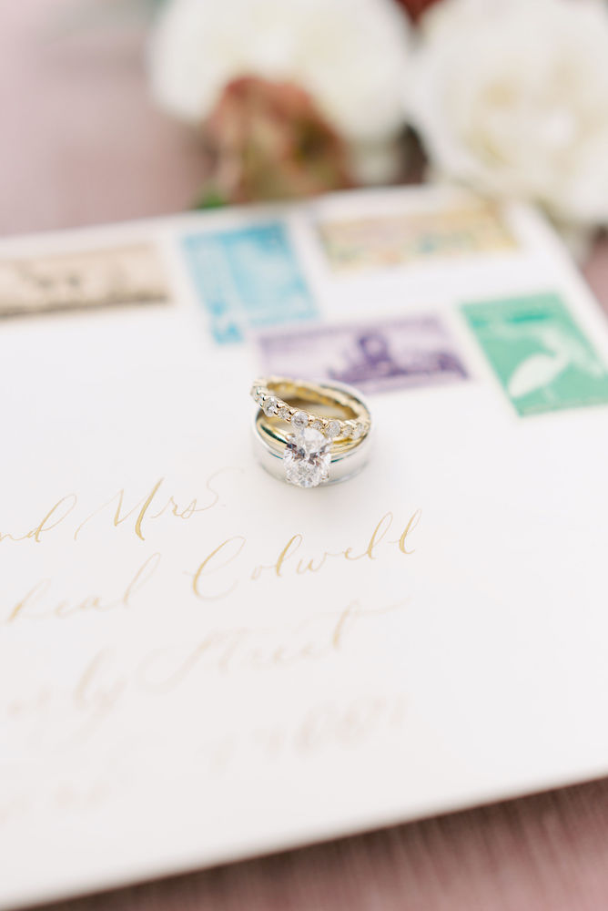 Wedding invitation envelope with calligraphy and wedding rings.