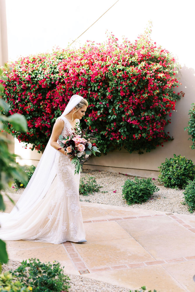Bride with bouquet walking to first look outdoors