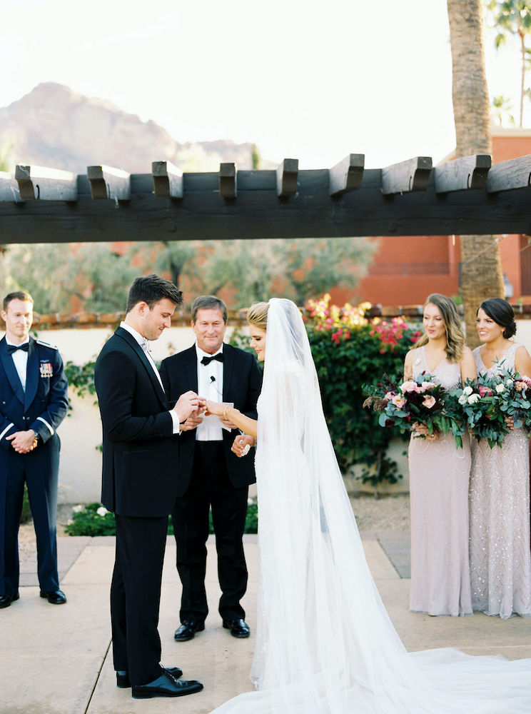 Bride and groom exchanging rings during ceremony at Omni Scottsdale