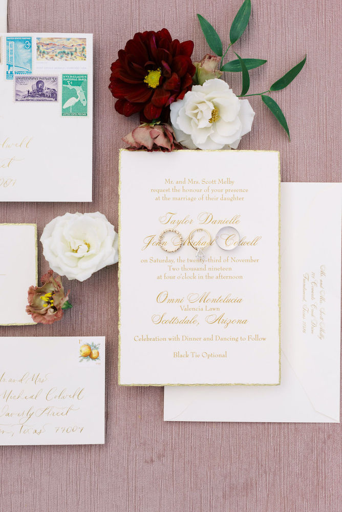 Gold wedding invitation and wedding rings