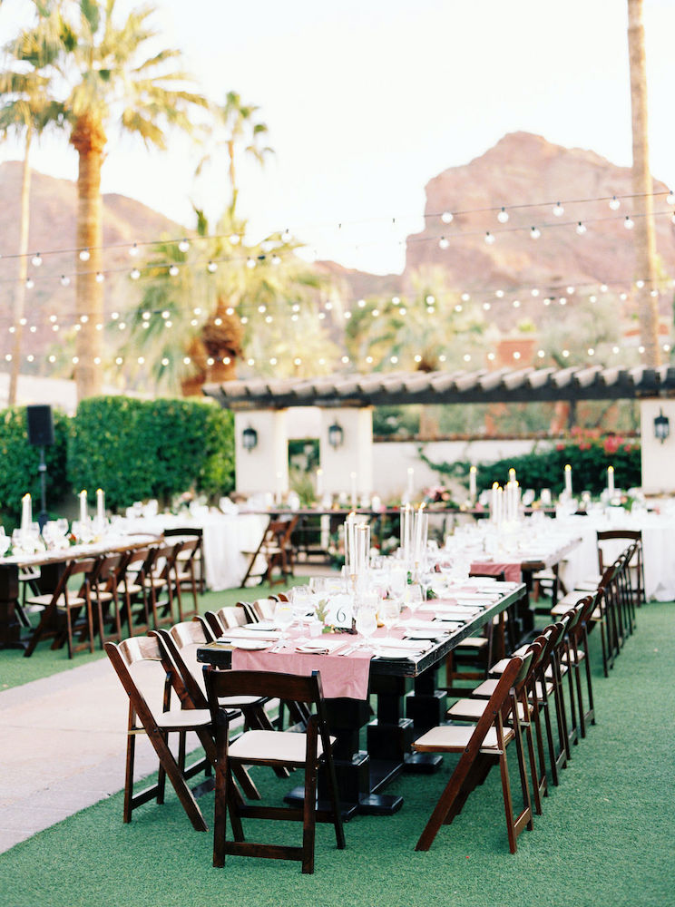 Wood tables and velvet table runner linens at wedding reception on Valencia Lawn at Omni Montelucia Scottsdale.